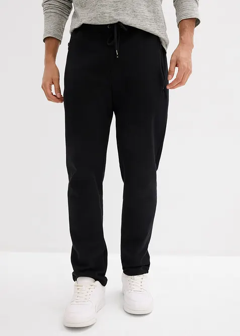 Jogginghose mit Reißverschlusstaschen in schwarz von vorne - bonprix