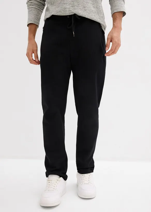 Jogginghose mit Reißverschlusstaschen in schwarz von vorne - bonprix