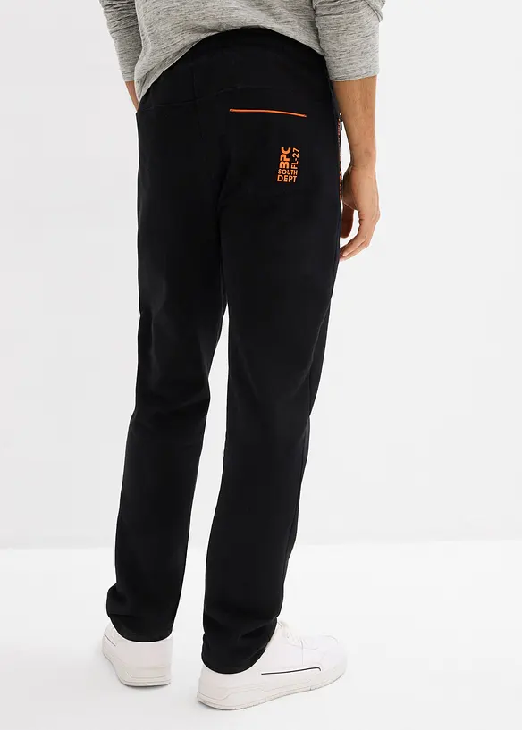 Jogginghose mit Reißverschlusstaschen in schwarz von hinten - bonprix