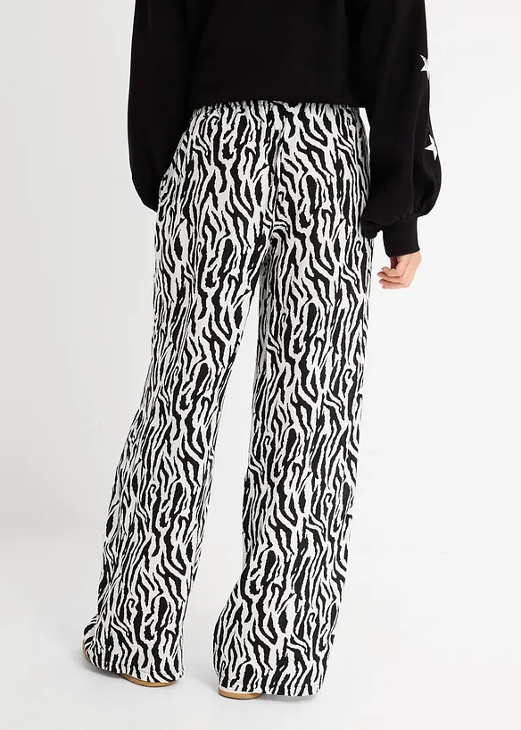 Schlupfhose aus fließender Viskose in schwarz von hinten - bonprix